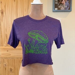 Purple Graphic Tee with Green Frog & Mushroom Design